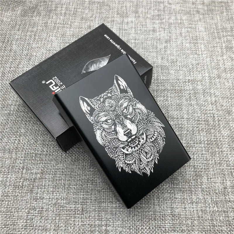 A black custom engraved cigarette case featuring a detailed wolf head design on a dark background.