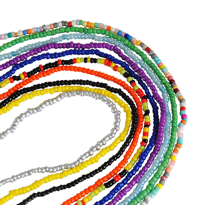 A spiral arrangement of colorful belly bead chains featuring various shades of black, white, blue, purple, orange, and green 