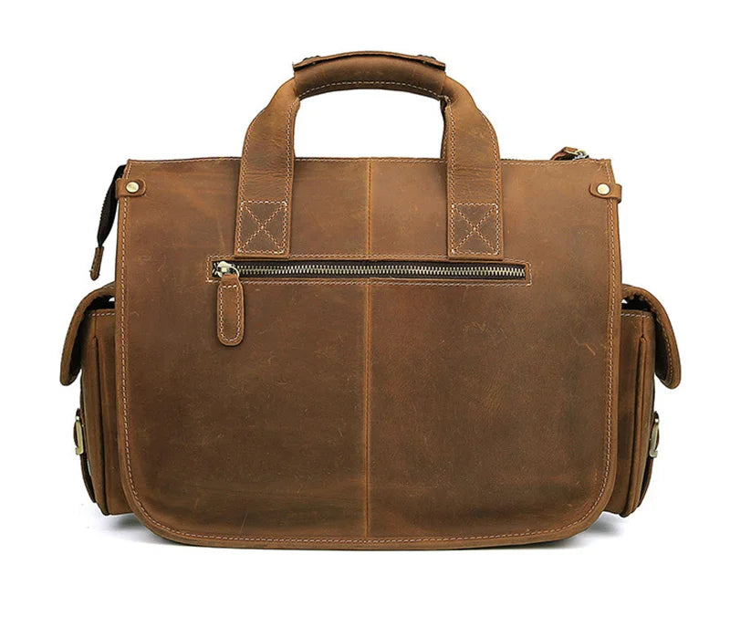 A brown genuine cowhide leather briefcase with a top handle and zippered compartment.