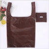 A brown leather eco-friendly foldable shopping bag is displayed next to a small brown bag.