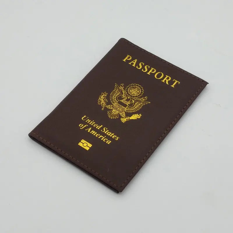 A dark brown leather passport holder embossed with the United States of America eagle design and text.