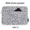 A black and white spotted laptop sleeve with a front pocket.