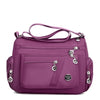 A purple waterproof nylon crossbody tote bag for women.