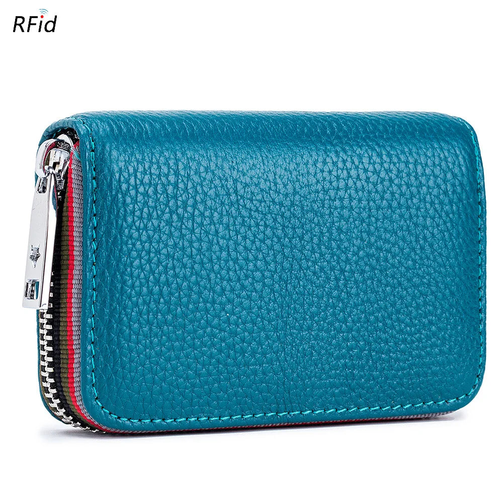 A teal leather accordion card holder wallet with a silver zipper and striped lining.