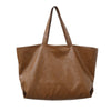 A brown oversized PU leather tote bag with a handle is shown from the front.