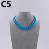 A bright blue acrylic link chain necklace displayed on a mannequin neck.