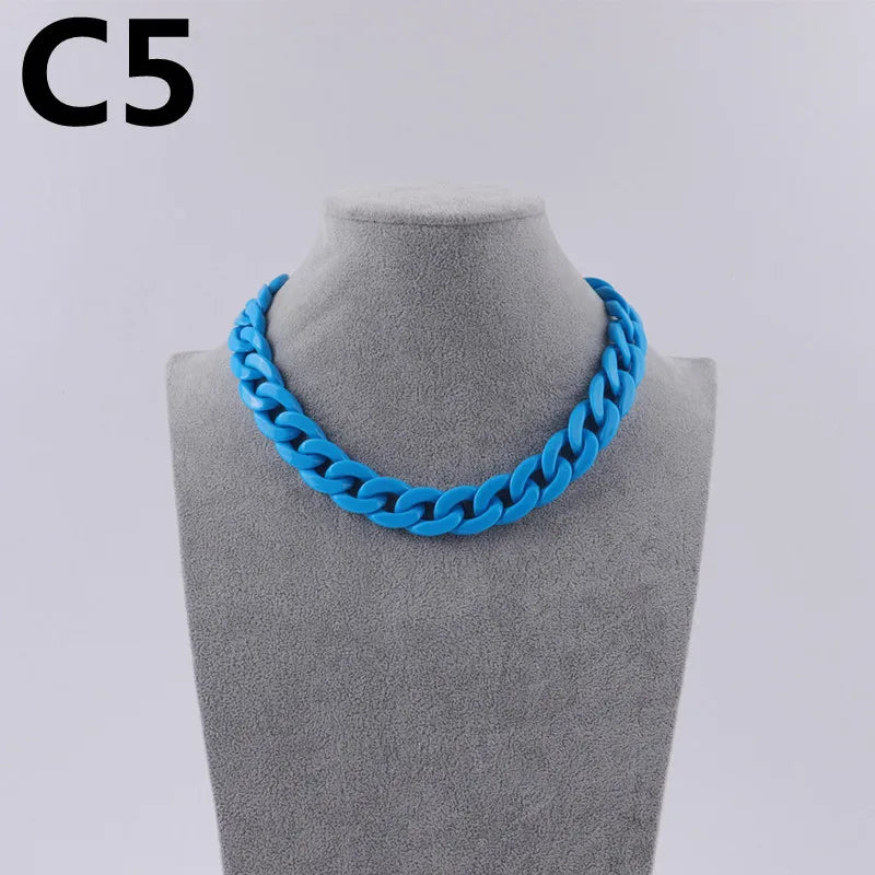 A bright blue acrylic link chain necklace displayed on a mannequin neck.