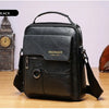 Black vintage PU leather crossbody messenger bag resting on a wooden surface.