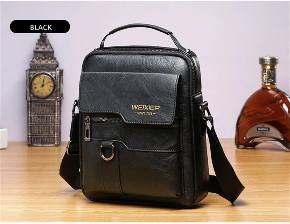 Black vintage PU leather crossbody messenger bag resting on a wooden surface.
