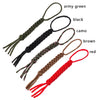 A collection of seven strands of paracord keychains and utility ropes in various colors including army green, black, camo, br