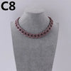 A close-up of a pink acrylic link chain necklace displayed on a mannequin neck.
