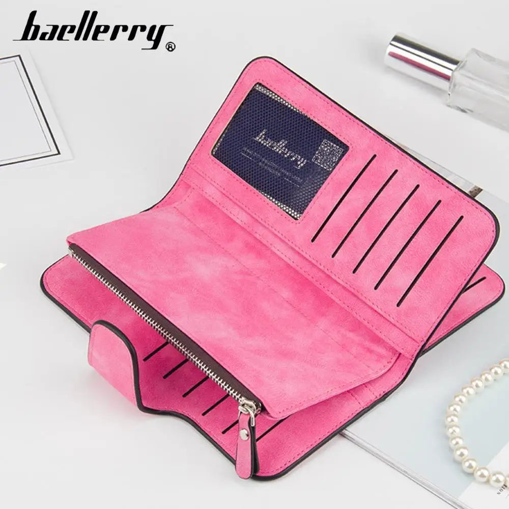 A pink leather card holder wallet with vertical stitching and a dark label is displayed on a white surface.