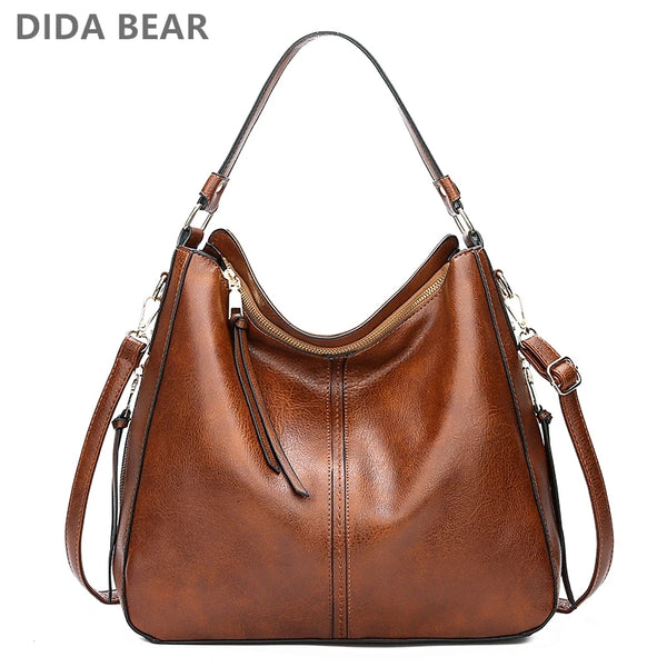 A brown vintage faux leather hobo shoulder bag with a zipper and leather strap.