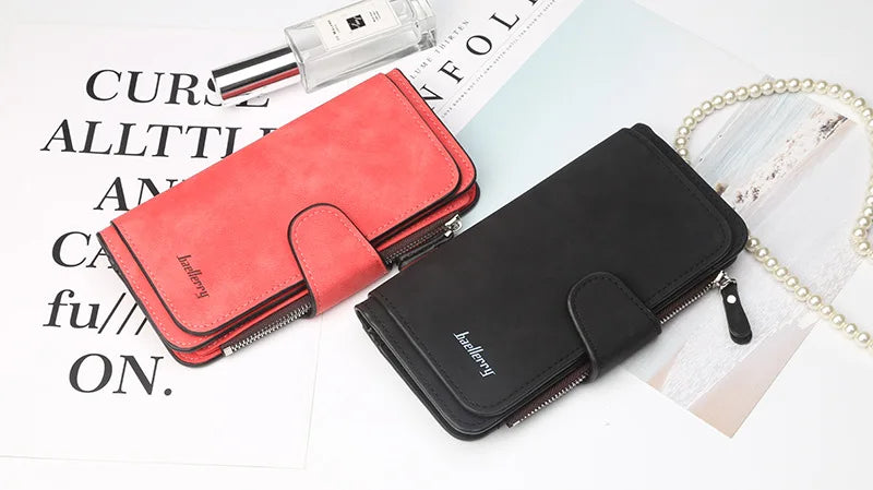 A red and black card holder wallet set featuring a leather pouch and a metal pen on a white background.