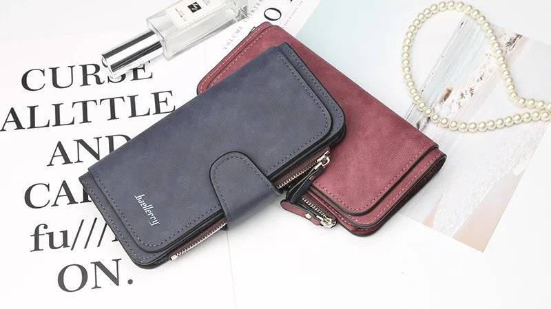 A dark gray elegant PU leather card holder wallet next to a maroon version and a pearl necklace on a white background.