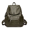 A dark olive green vintage soft leather backpack with a zippered top and front pocket.