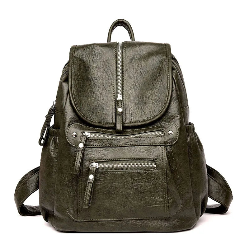 A dark olive green vintage soft leather backpack with a zippered top and front pocket.