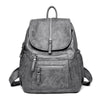 A gray vintage soft leather backpack for women shown from the front.