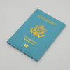 A teal leather passport holder with gold lettering and an eagle emblem, featuring the flag of the United States of America.