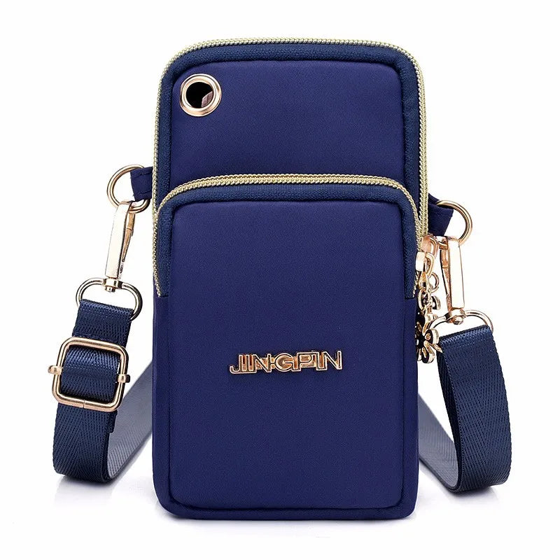 A navy blue waterproof nylon crossbody bag with gold hardware and a matching strap.