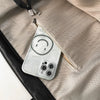 A white phone case with a smiley face is shown inside an oversized beige PU leather tote bag.