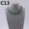 A close-up of a green acrylic link chain necklace displayed on a gray mannequin neck.