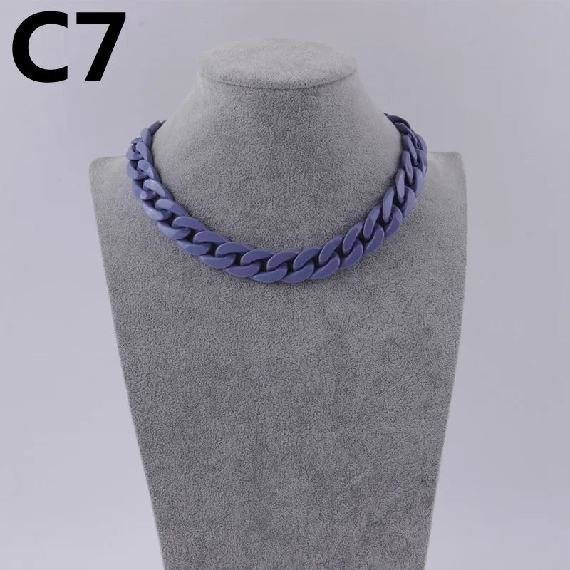 A purple acrylic link chain necklace displayed on a mannequin neck.