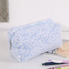 Bolsa organizadora de cosméticos de piel sintética azul claro con estampado de leopardo