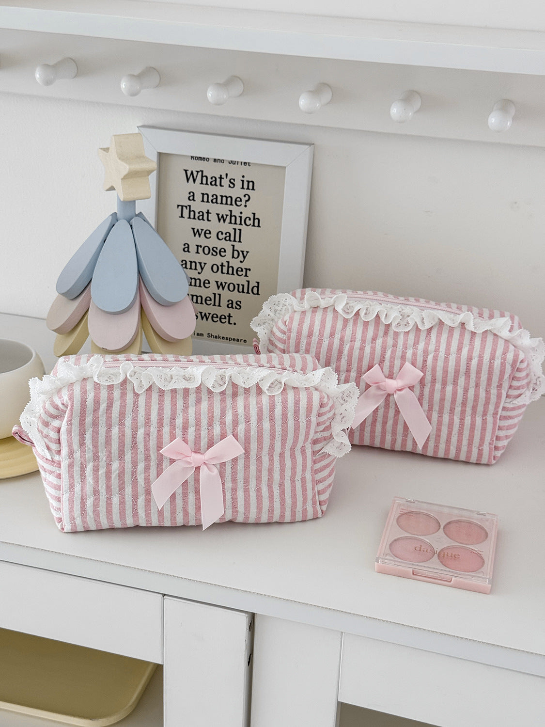 Pink rose sweetheart cosmetic storage pouch with a white lace trim and a wooden flower charm.