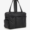 A black large capacity women's travel duffle bag with padded straps.