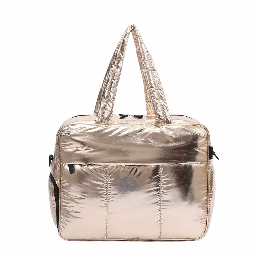 A large capacity women's travel duffle bag in shiny gold metallic material.