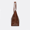 A brown crocodile print tote bag with a top handle shown from the front.