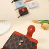A collection of vintage letter print compact wallets in various colors and patterns, displayed on a light background.