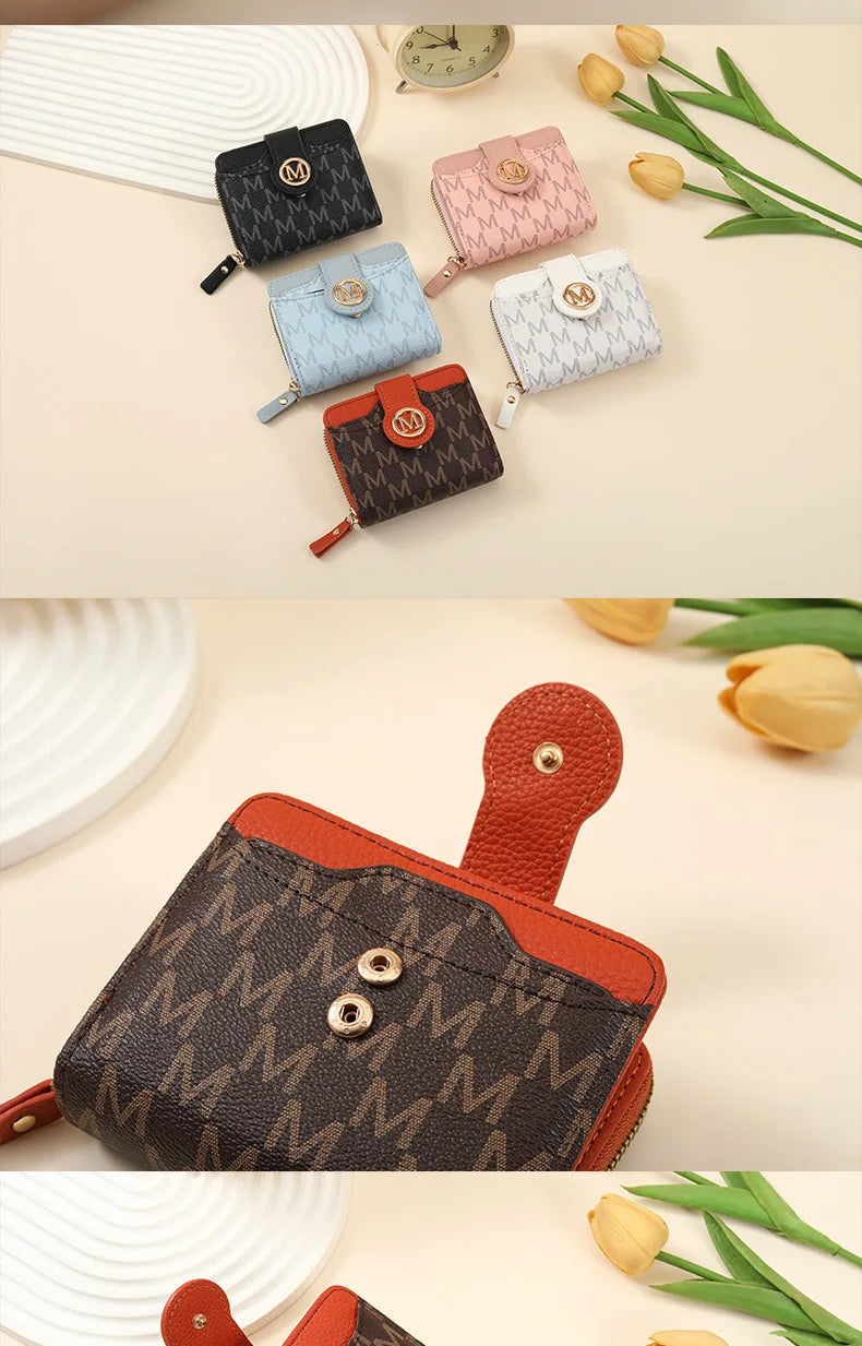 A collection of vintage letter print compact wallets in various colors and patterns, displayed on a light background.