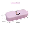 A light purple PU leather hard shell eyeglass case with a black letter charm, shown from the side.