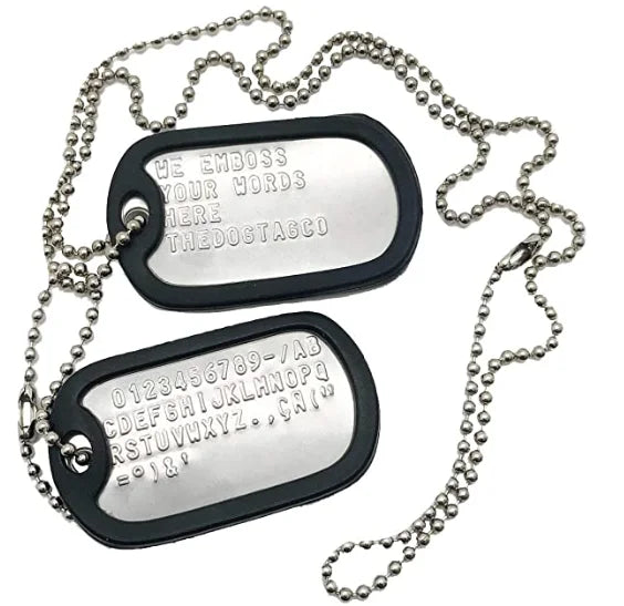 A set of two personalized military dog tag necklaces with engraved names and information on silver chains