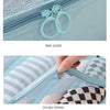 Close-up of a light blue zipper with a ring slider and double edging detail on a fabric organizer.