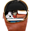 A brown PU leather crossbody sling bag is shown open, revealing a lined interior with various small accessories.