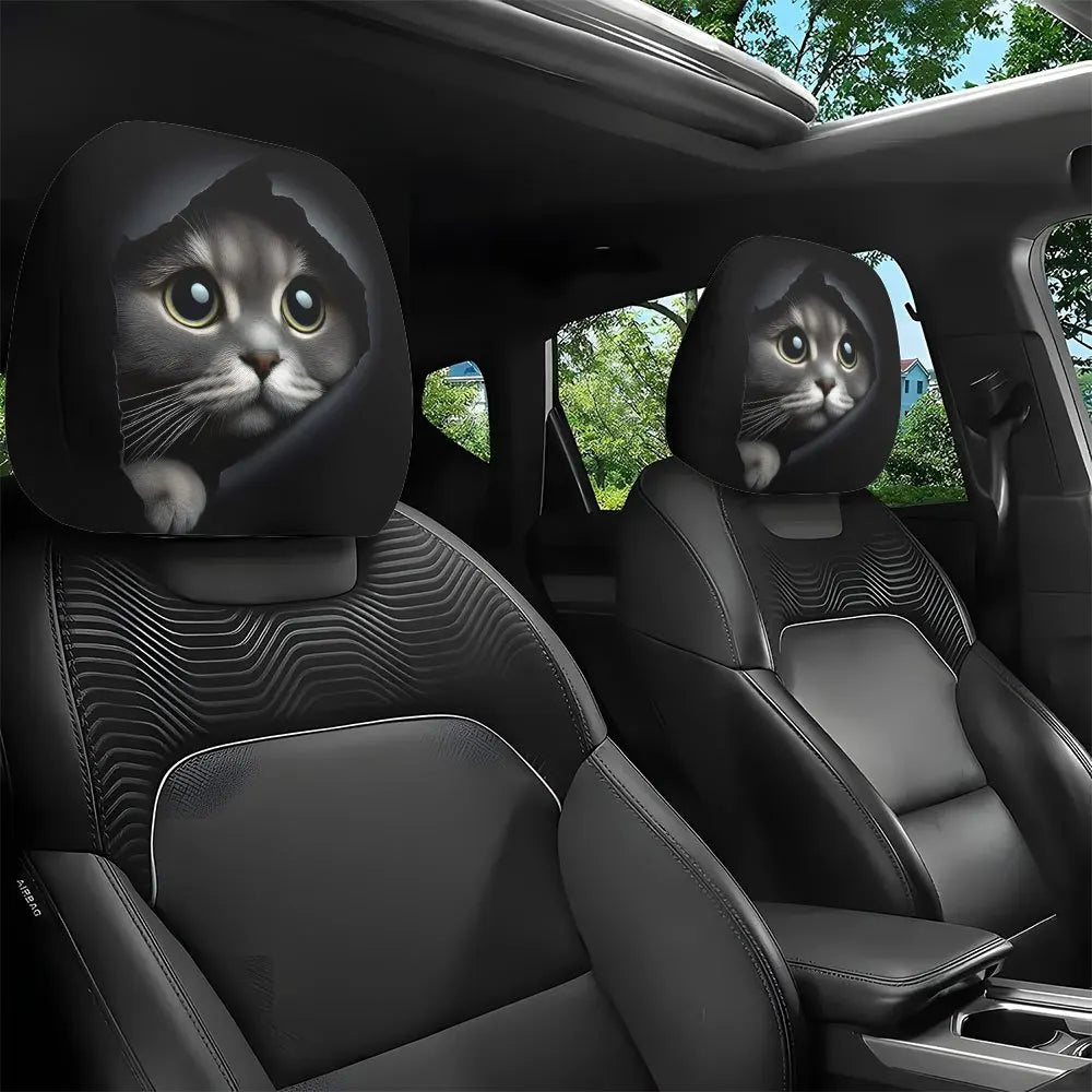 Two black car headrest covers featuring a cat face design are shown in a vehicle interior.