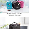 Multiple colored portable toiletry bags displayed on a white table and a white chair.