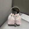 A pink crystal-embellished evening clutch with a silver chain and a matching circular mirror.