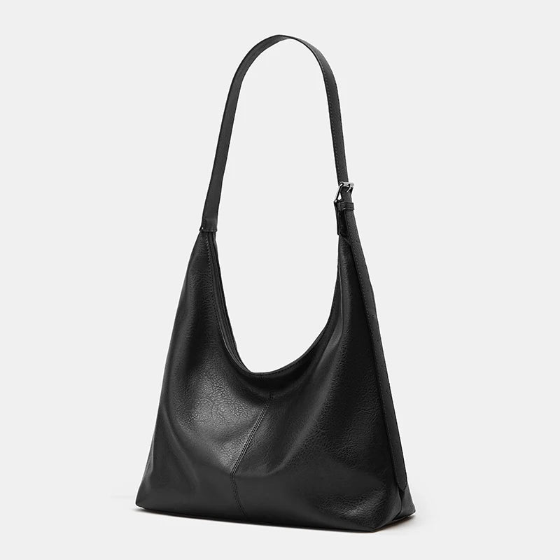 A black women's soft PU leather retro tote bag with a zipper closure.