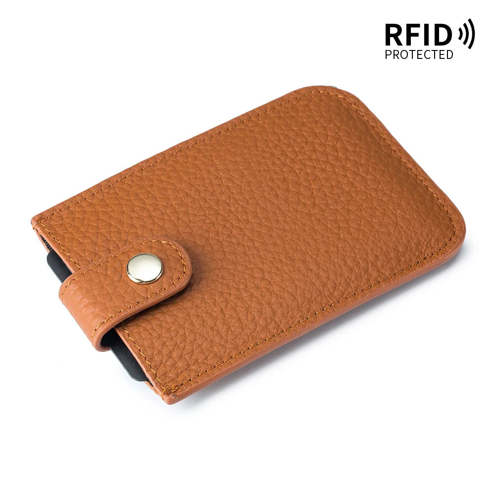 A brown genuine leather slim card holder with a stitched texture and a silver metal clasp.