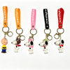 A set of five Snoopy 3D silicone keychains in various colors and styles attached to orange, pink, and black leather straps.