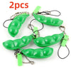 Two green oval silicone fidget toys attached to metal chains and jump rings for keychains