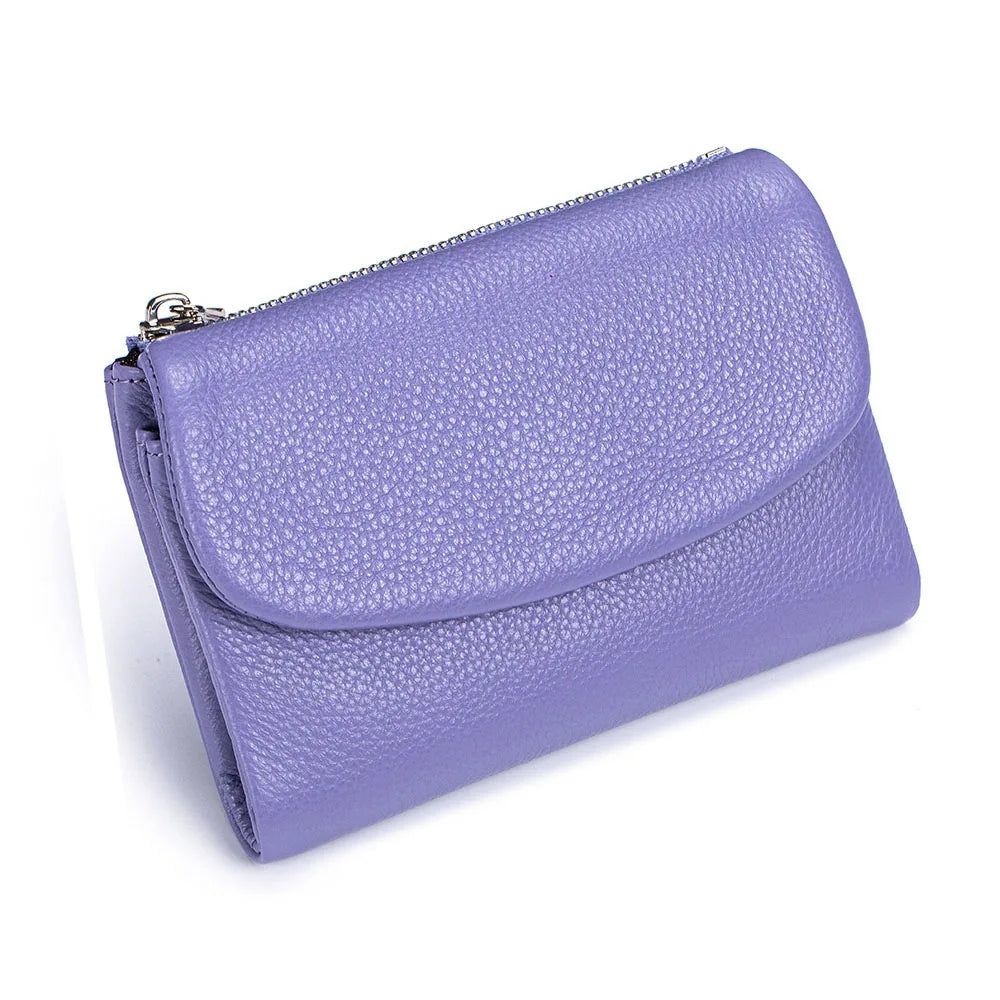 A purple genuine leather mini card holder wallet with a zippered closure.