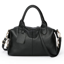 Black soft leather tote bag with a padded flap and adjustable shoulder strap.