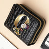 A black PU leather double-zip clutch wallet with gold trim and a floral cartoon print.