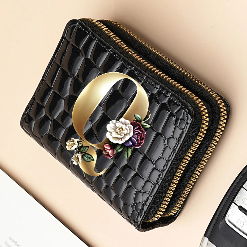 A black PU leather double-zip clutch wallet with gold trim and a floral cartoon print.