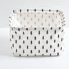 A white storage basket with a black pine tree pattern, made of waterproof cotton linen.